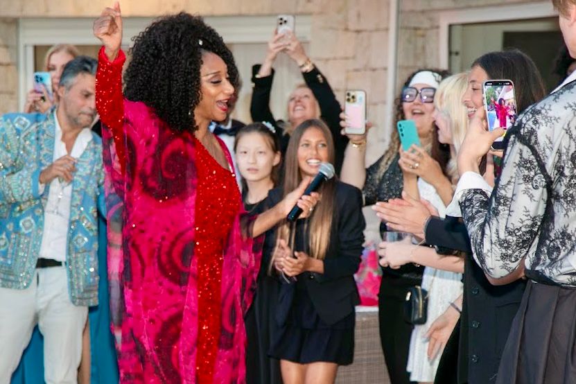 Guests joining a singer in red during the gala