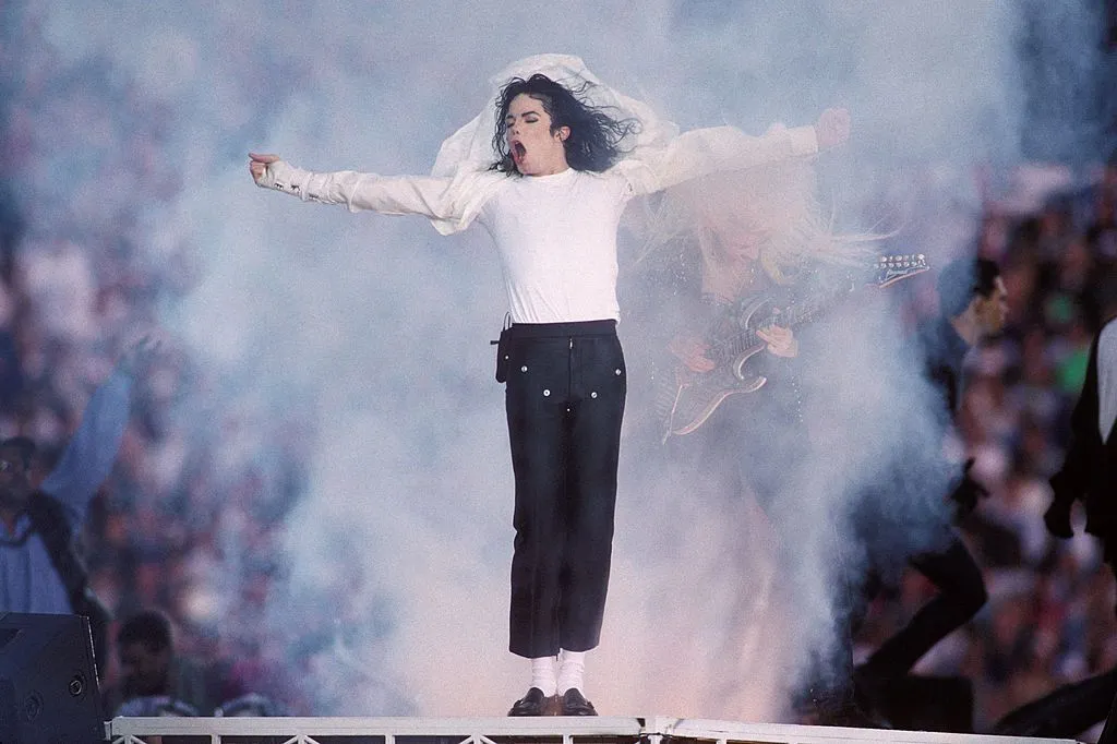 Michael Jackson performing with his arms outstretched